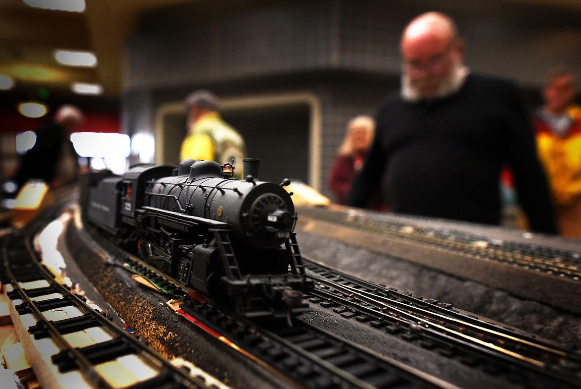 Flathead HO RR Module Group member Dennis Gray keeps an eye on his locomotive during the group's demonstration at the Kalispell Center Mall Saturday, November 27. (Jeremy Weber/Daily Inter Lake)