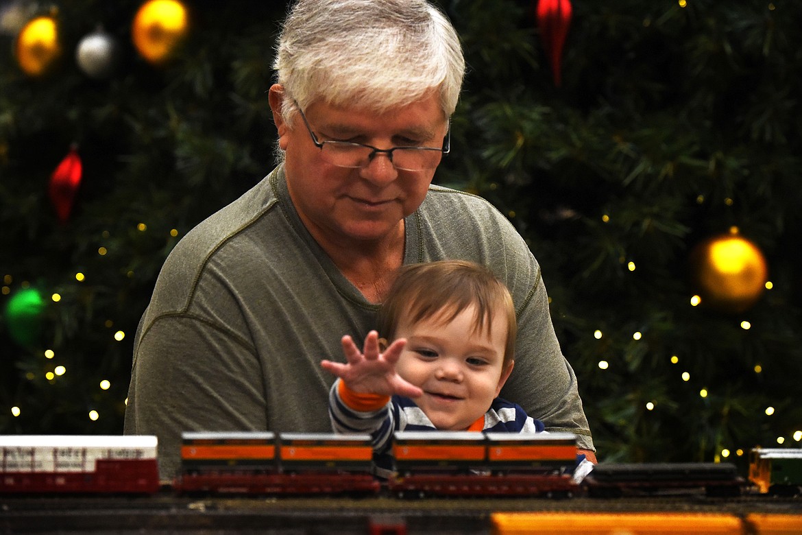 Bill Luce and his 1-year-old grandson, Phoenix WeberLuce, enjoy the model railroad module display at the Kalispell Center Mall Saturday, November 27. (Jeremy Weber/Daily Inter Lake)