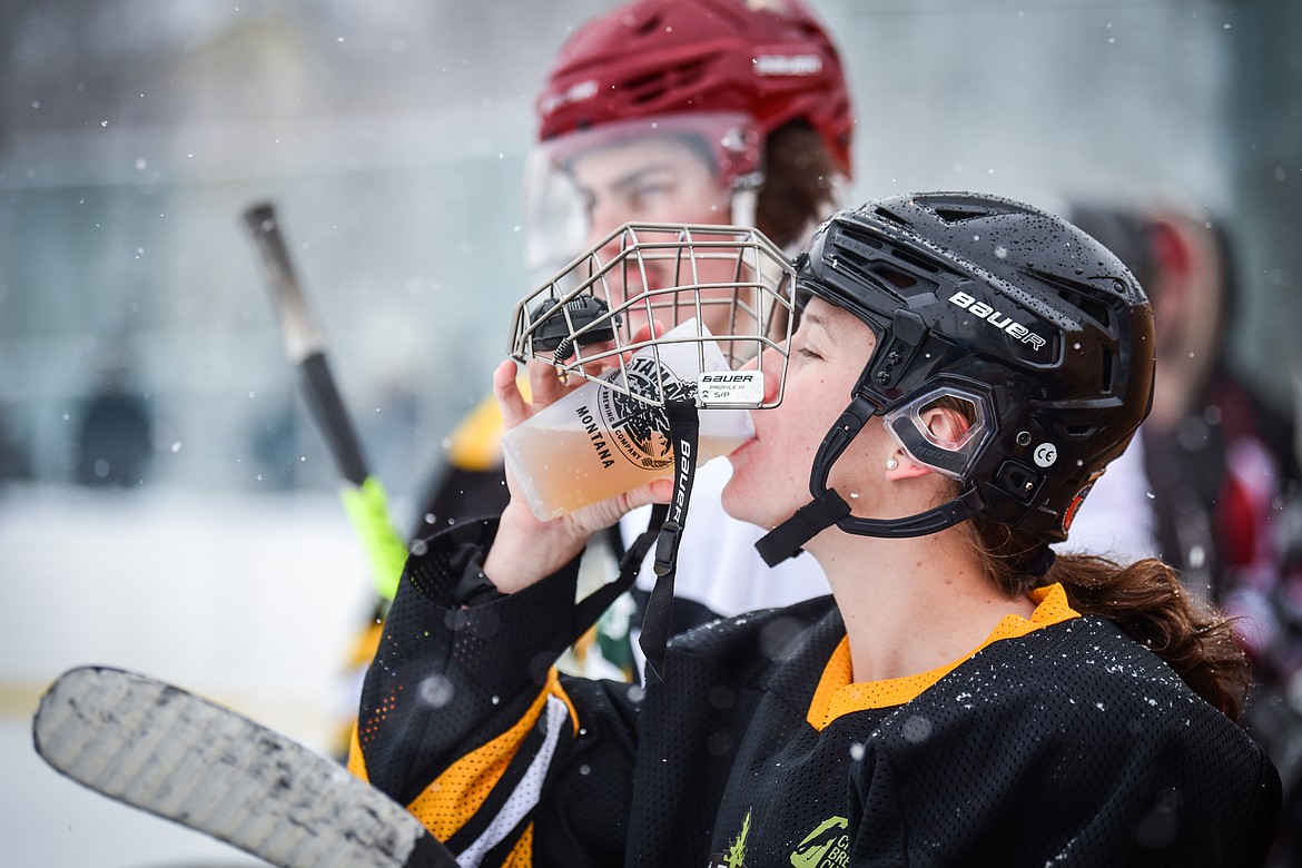 Tamarack Brewery's Janessa Courtney (3) takes a sip of beer during their game against the Idaho North Tropics at the Craft Brewers Cup at Woodland Park Ice Center in Kalispell on Saturday, Dec. 4. (Casey Kreider/Daily Inter Lake)