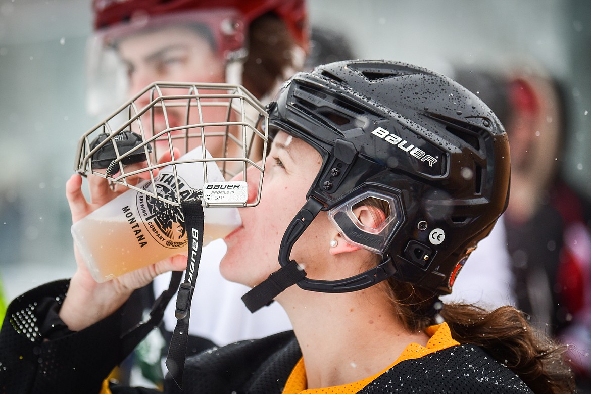 Tamarack Brewery's Janessa Courtney (3) takes a sip of beer during their game against the Idaho North Tropics at the Craft Brewers Cup at Woodland Park Ice Center in Kalispell on Saturday, Dec. 4. (Casey Kreider/Daily Inter Lake)