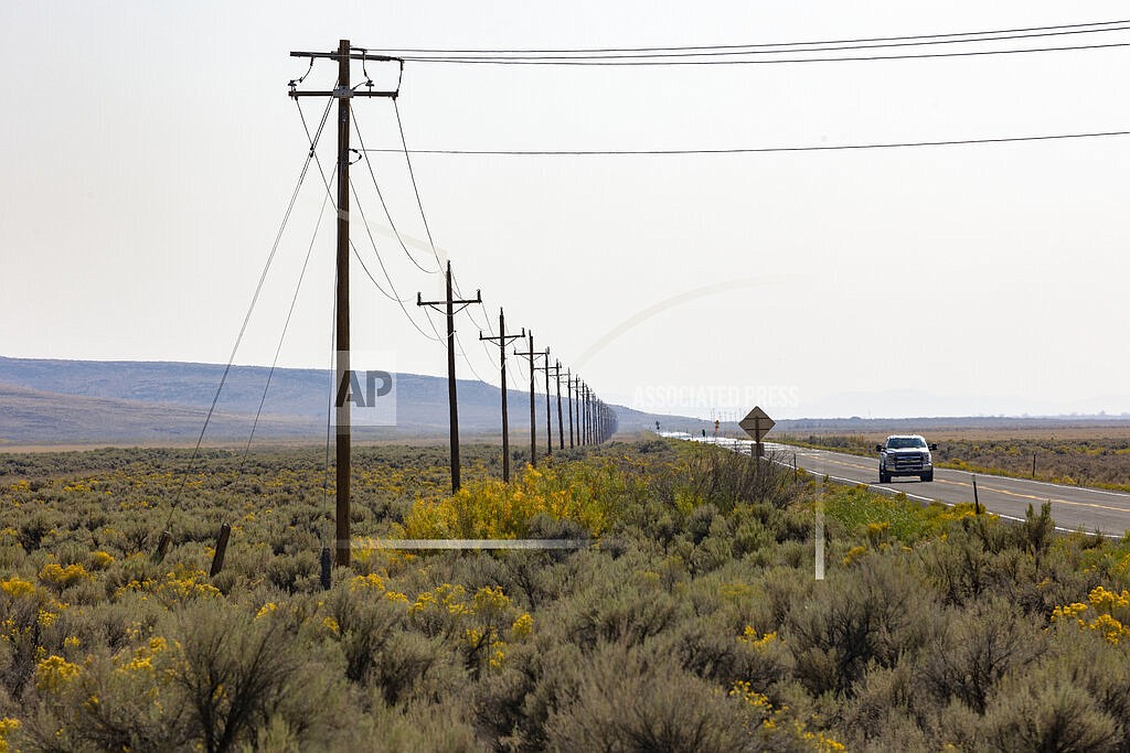 The only power line into the Duck Valley Indian Reservation is pictured along Highway 51 near the Idaho/Nevada border, Wednesday, Sept. 8, 2021. The Duck Valley Indian Reservation was established in the 19th century, comprising 450 square miles it is home to the Shoshone-Paiute Tribes. (Kyle Green/NPR, via AP)