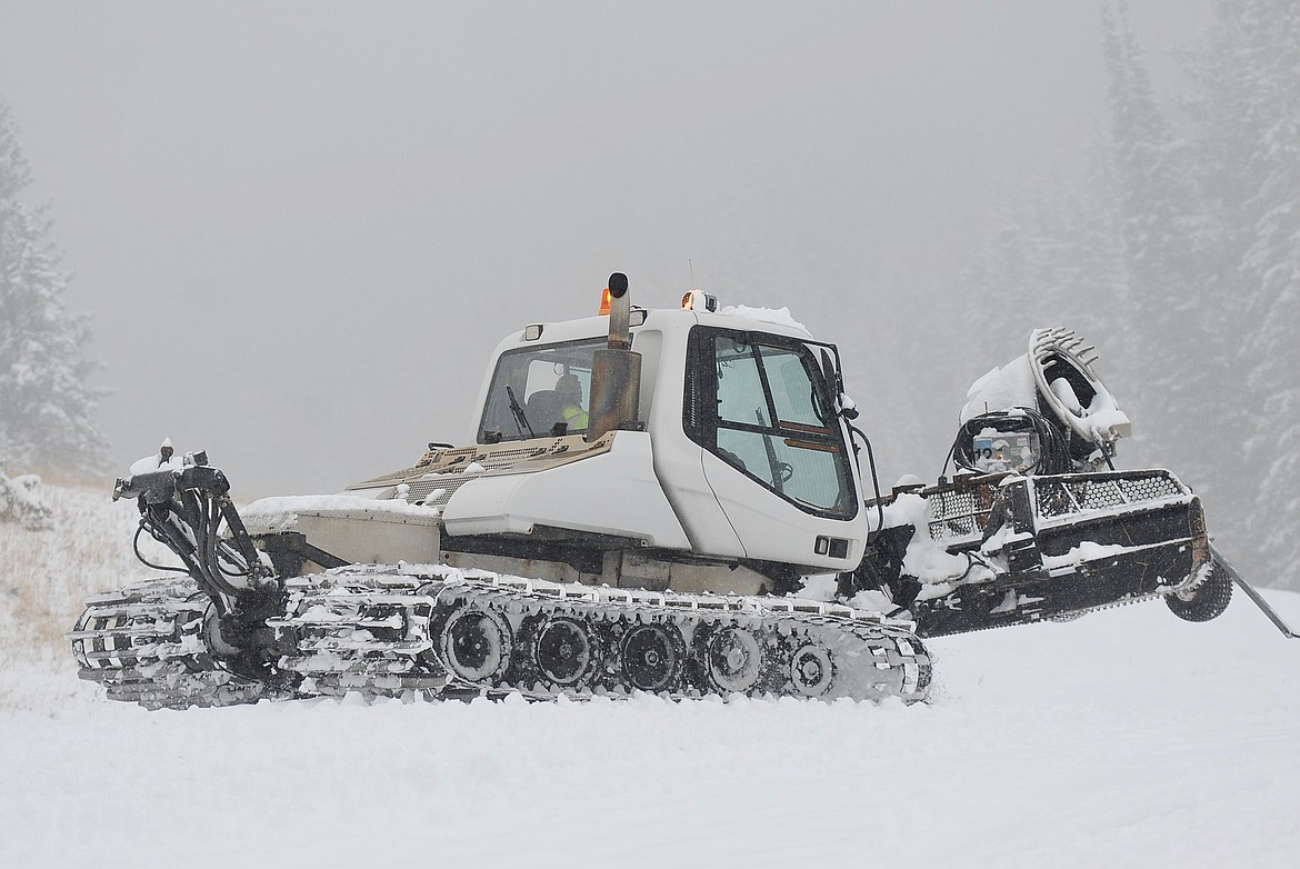 A snow groomer moves snowmaking equipment near the Toni Matt slope at Whitefish Mountain Resort on Saturday, Dec. 4. (Matt Baldwin/Daily Inter Lake)