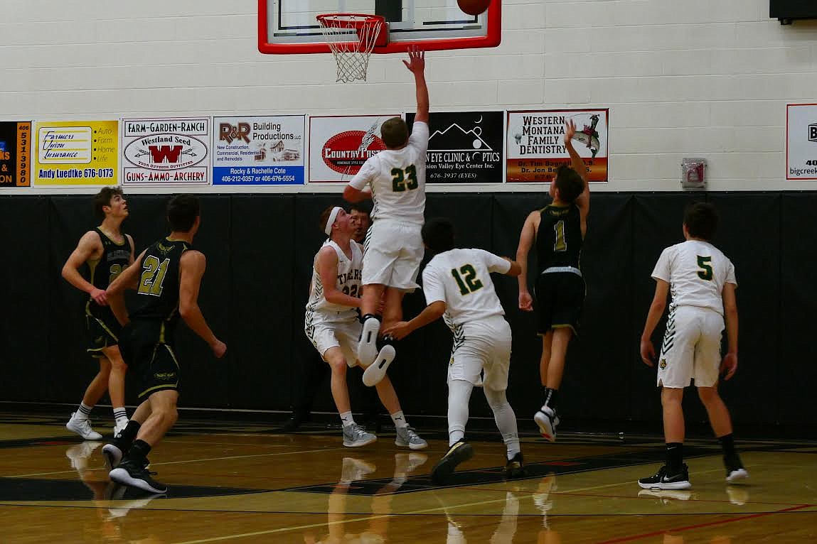 St. Regis’ John Pruitt (23) goes up for a layup as Tanner Day (22) waits for a potential put-back against Seeley Swan Friday in the Ronan Tip-off Tournament. (Chuck Bandel/Mineral Independent)