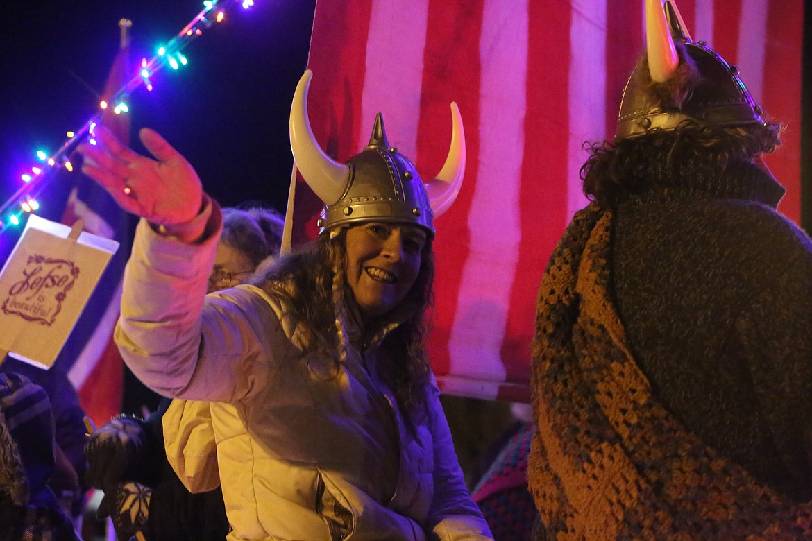 A rider on the Sons of Norway float waves to the crowd during the 26th annual Agricultural Parade Friday in Moses Lake.