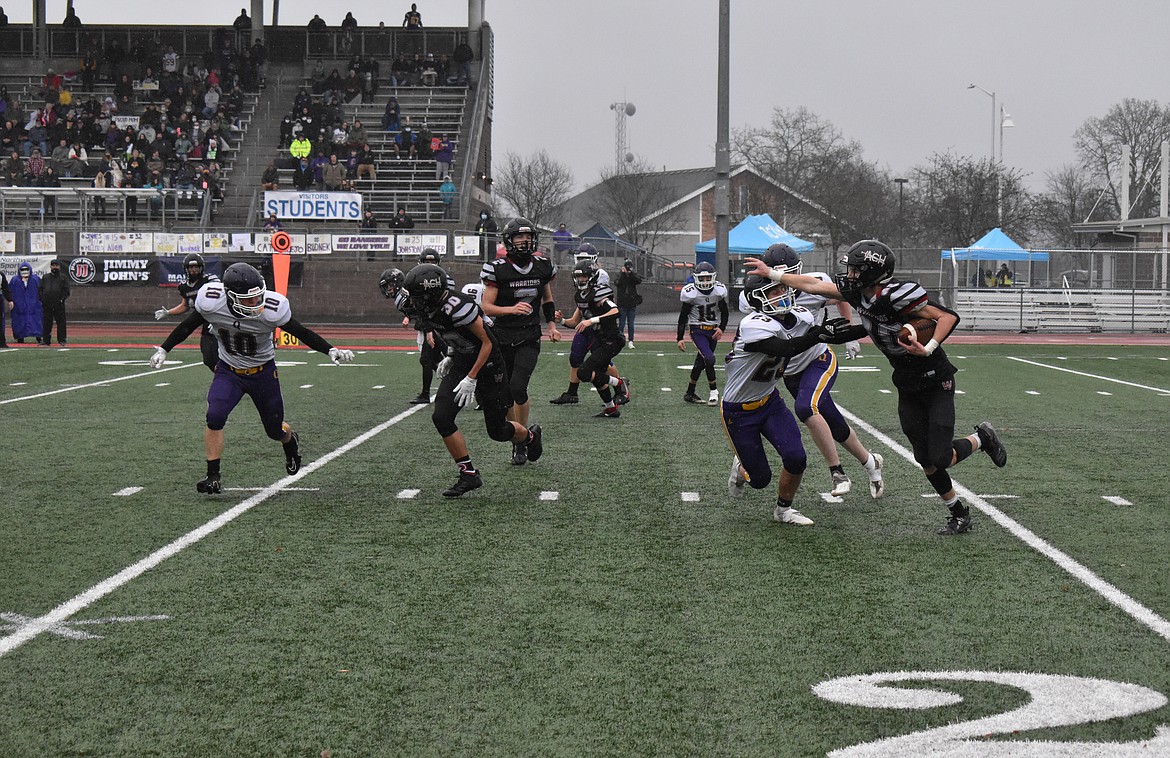 ACH senior Grady Murray (10) holds off a Quilcene High School player Saturday in the 1B Washington Interscholastic Activities Association Gridiron Classic: State Football Finals in Tacoma.