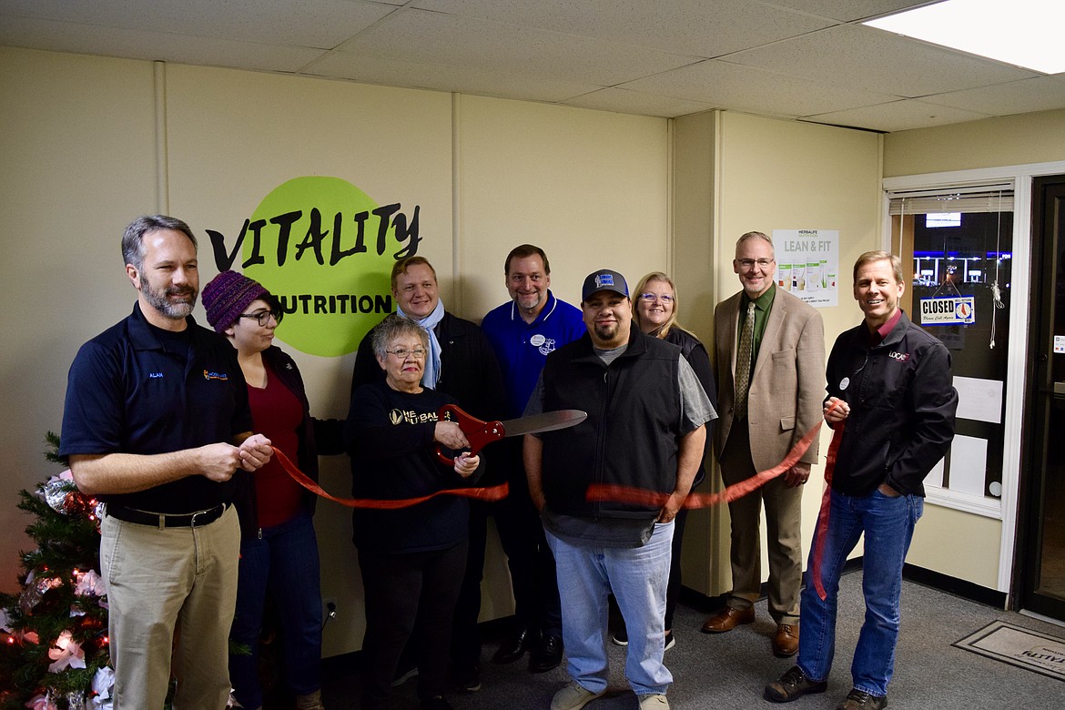 Judy Rocha, flanked by her son Juan Rocha (right) and family friend Joy Mondaca (left), along with members of the Moses Lake Chamber of Commerce, cut the ribbon and celebrate the formal opening Thursday of Judy’s business, Vitality Nutrition. It sells Herbalife supplements, energy drinks and low-calorie and low-carb shakes and snacks. Vitality Nutrition is at 1001 W. Broadway Ave., in the West Broadway Plaza, near the intersection of West Broadway and Third Avenue, in Moses Lake.