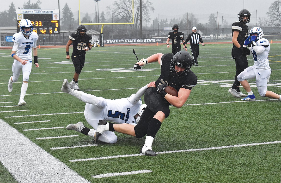 Royal High School senior Avery Ellis (22) is taken down by an Eatonville High School player Saturday in the 1A Washington Interscholastic Activities Association Gridiron Classic: State Football Finals in Lakewood.