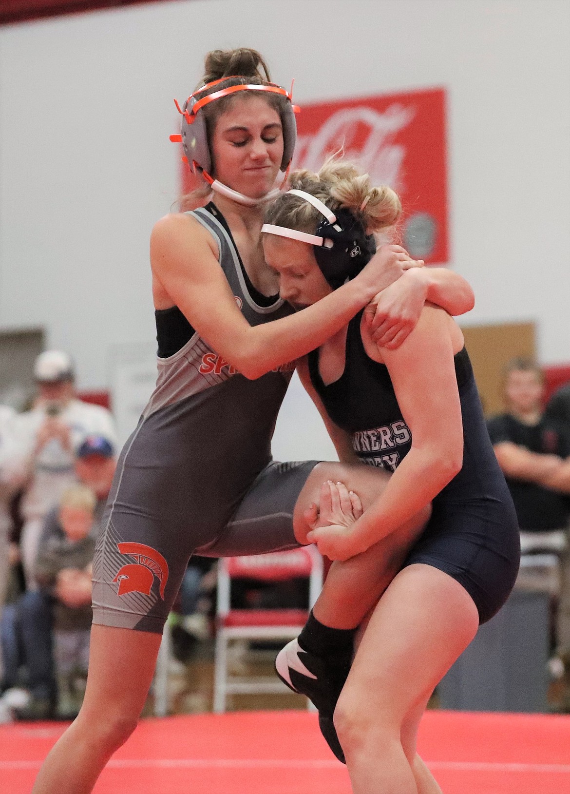 Kailee Davis (left) tries to escape the grasp of her opponent during a match Saturday at Sandpoint High.