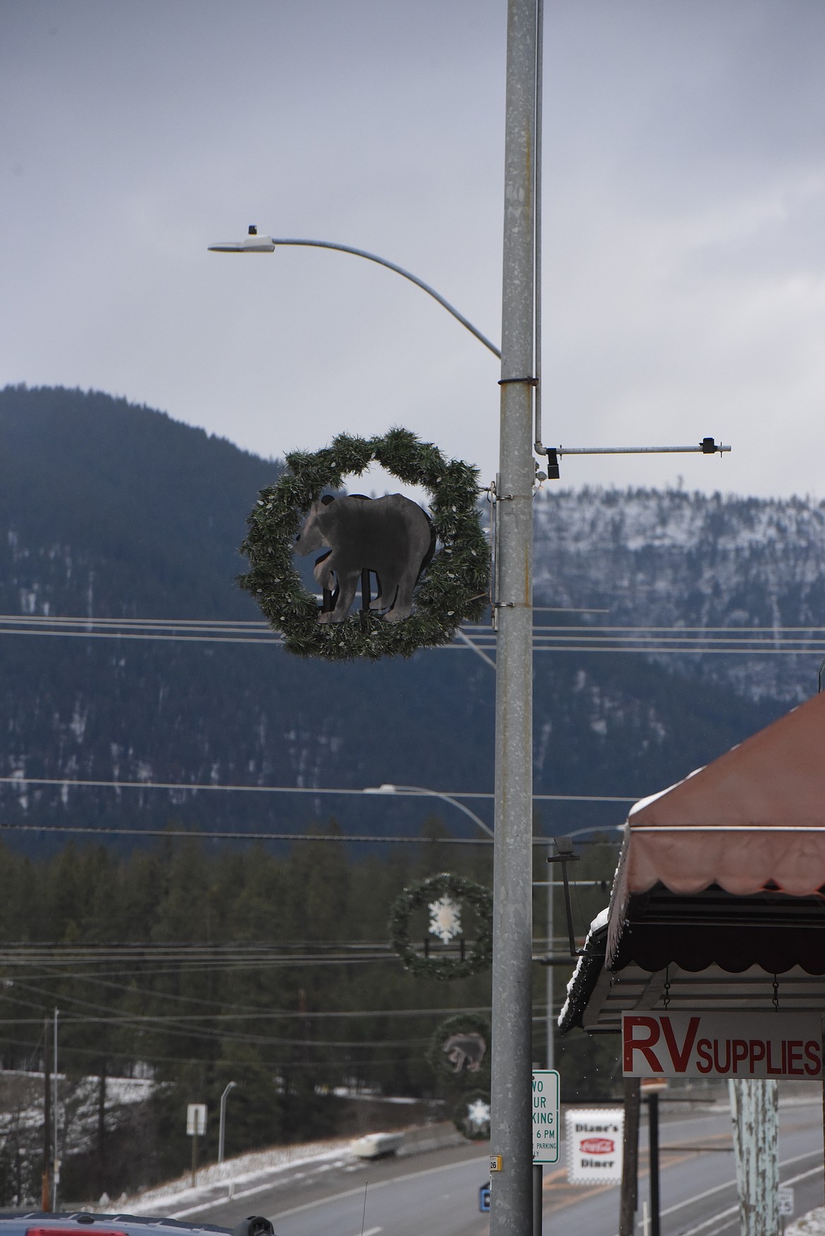 Holiday wreaths line the light poles along California Avenue. (Derrick Perkins/The Western News)