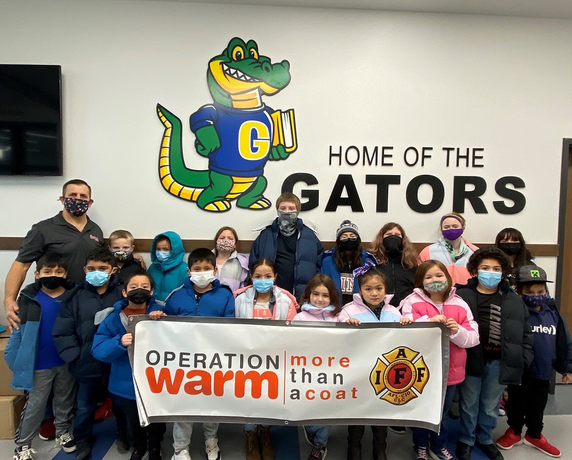 Students from Groff Elementary School show off their new coats, courtesy of the Operation Warm project sponsored by the Moses Lake Firefighters IAFF Local 1258.