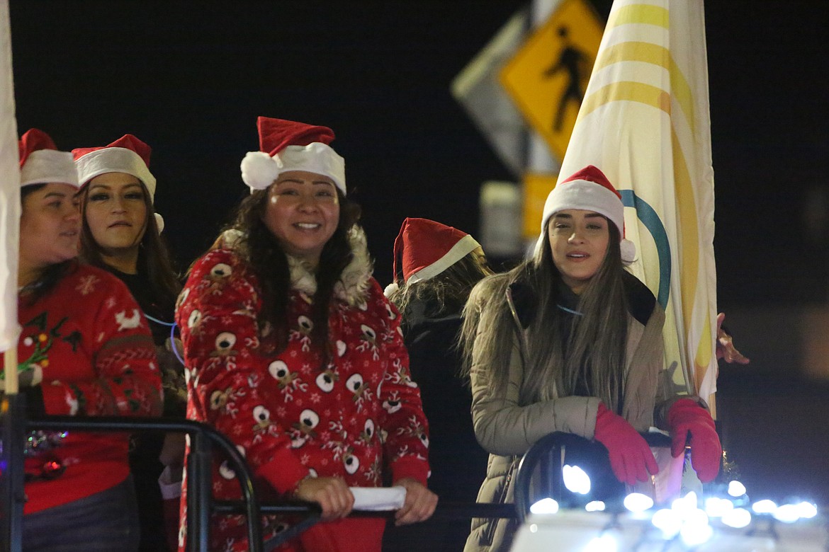Riders on the Columbia Basin Health Association float enjoy A Christmas Miracle on Main Street parade in Othello Saturday.