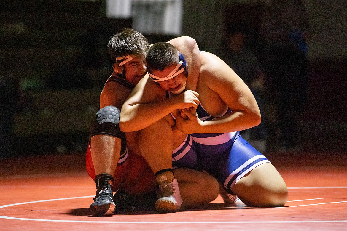 Greg Belgarde battles Donald Riess from Bonners Ferry in a heavyweight match Wednesday.