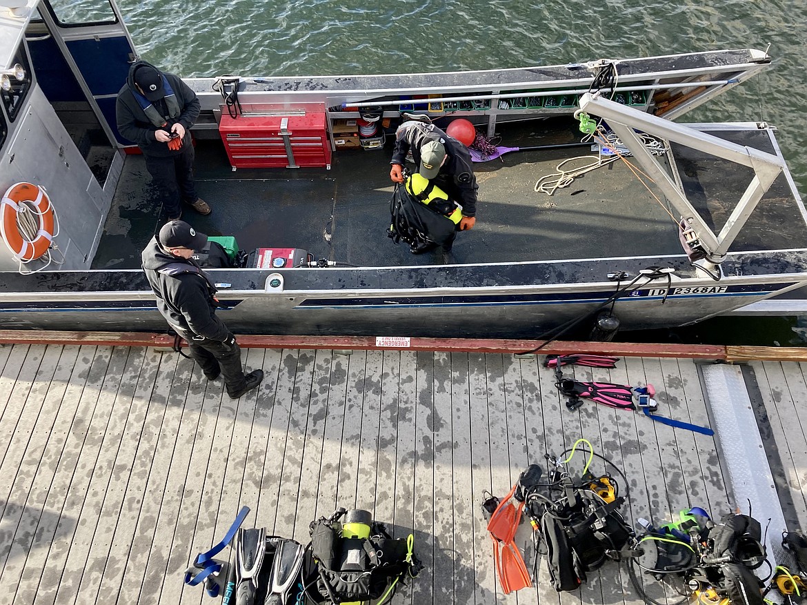 Members of the Kootenai County Sheriff's Office dive team get ready for a second trip on the water to extract trash from Lake Coeur d'Alene around the Tubbs Hill and Third Street boat launch area Wednesday. HANNAH NEFF/Press