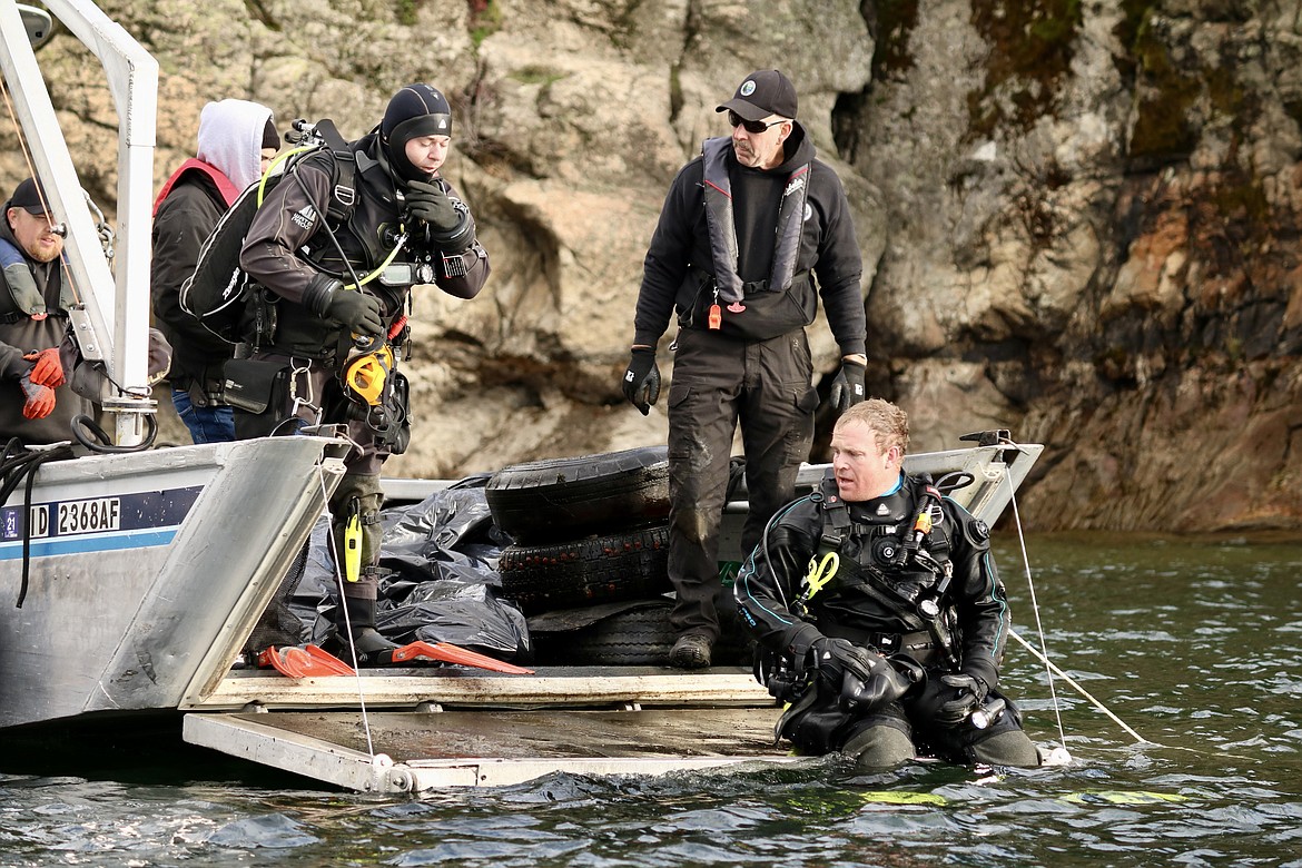 In a team effort, the KCSO dive team, divers from Jake’s Scuba Adventures, volunteers and the City of Coeur d’Alene Parks Department spent about four hours cleaning up around 100 square feet of underwater surface of the lake around Tubbs Hill and the Third Street boat launch. From left, Jake Strange, Operations Manager for Kootenai County Parks and waterways; Deputy Andrew Carney; Sergeant Jeremy Geurin; Doug Williams from Kootenai County Parks and Waterways Maintenance; and Sergeant Justin Arts. HANNAH NEFF/Press