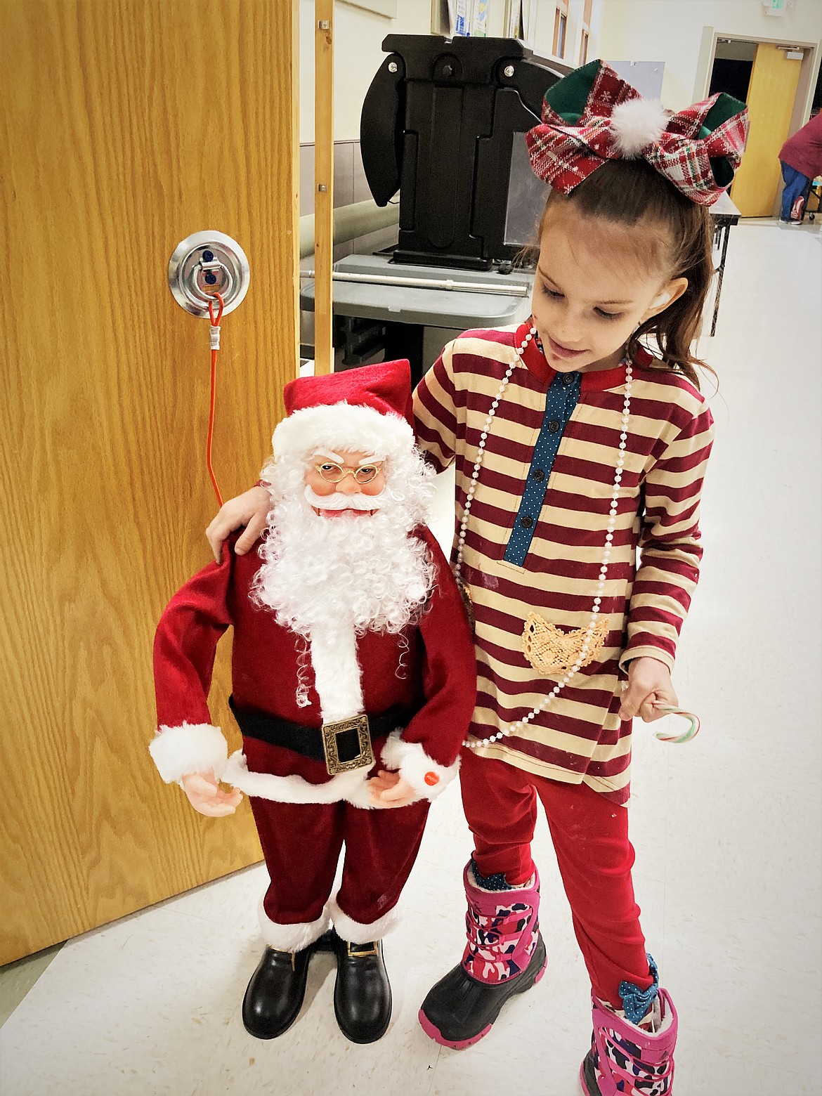 Kristina McNutt of Ravalli hangs out with Santa. (Carolyn Hidy/Lake County Leader)