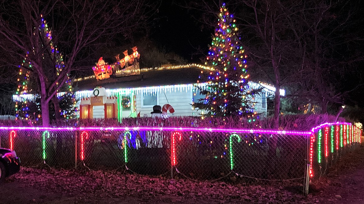 A St. Ignatius home, bright and cheery on a dark and stormy night. (Carolyn Hidy/Lake County Leader)