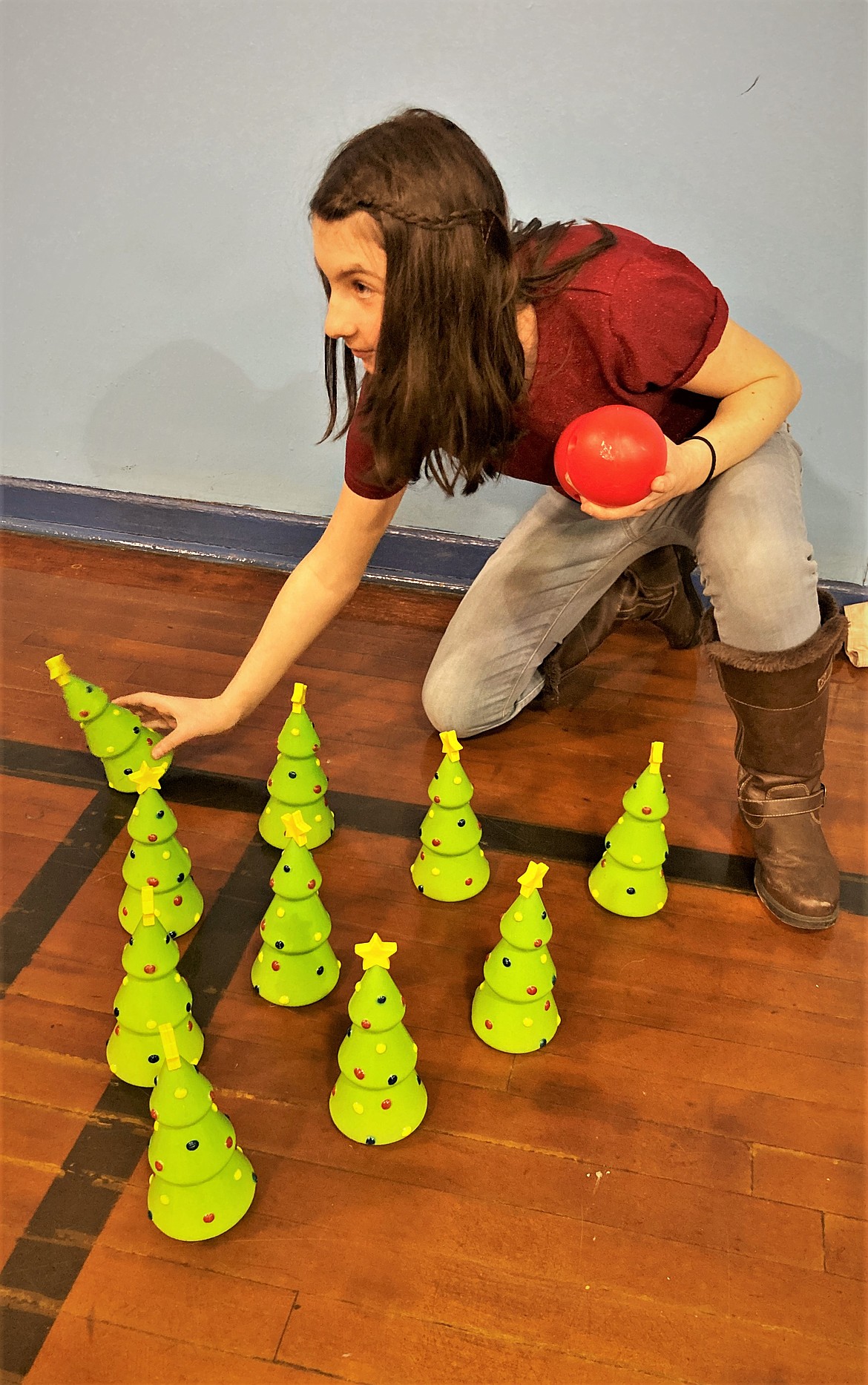 Resetting the bowling "pins" at the St. Ignatius Christmas Carnival. (Carolyn Hidy/Lake County Leader)