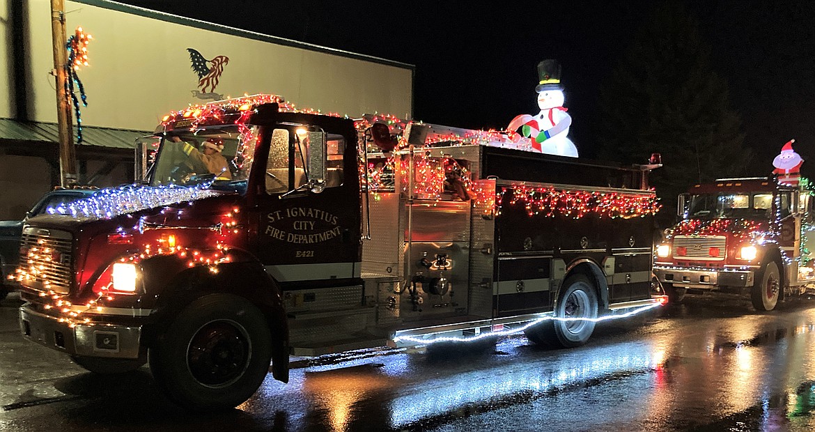 Bringing the bright spirit of the season to St. Ignatius, despite the cold downpour Saturday night. (Carolyn Hidy/Lake County Leader)