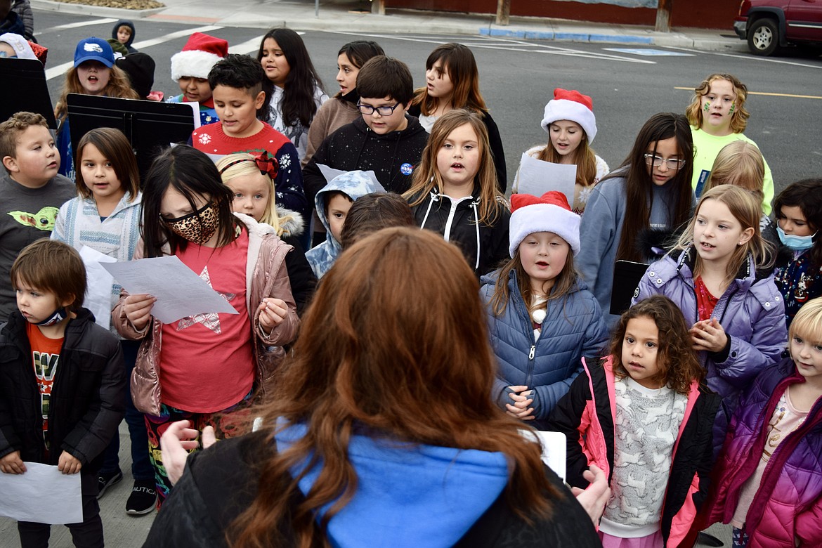 Students from Soap Lake Elementary School, under the direction of music teacher Allison Pheasant, sing Christmas songs in Sam Israel Panayiri Square on Saturday during the town’s annual Winterfest celebration.