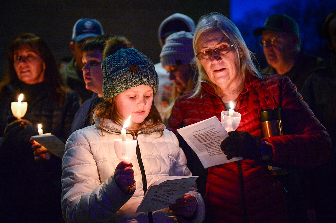 Alivia Lundstrom and Lynda Sundberg sing "Silent Night" during the annual Blue Light Tree Lighting Ceremony to honor fallen law enforcement officers outside the Flathead County Justice Center in Kalispell on Thursday, Dec. 9. (Casey Kreider/Daily Inter Lake)