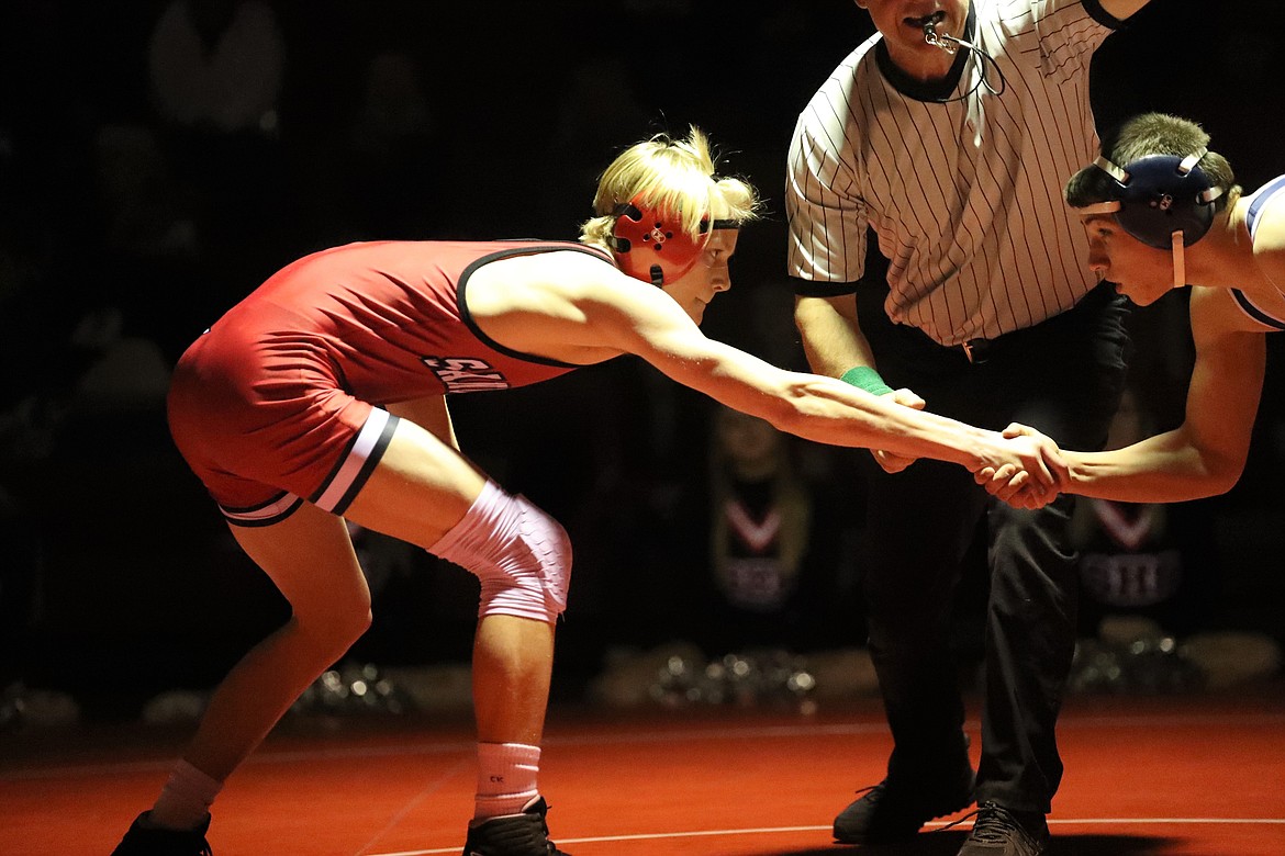 Forrest Ambridge (left) shakes hands with Bonners Ferry's Porter Blackmore prior to their match Wednesday.