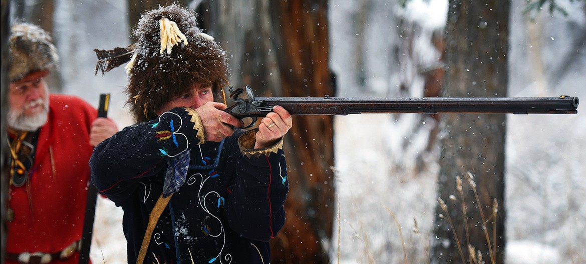 Gene Gordner, right, looks on as Rod Douglas takes aim with his flintlock rifle during a gathering of the Flathead Muzzleloaders Association Saturday, Dec. 4. (Jeremy Weber/Daily Inter Lake)