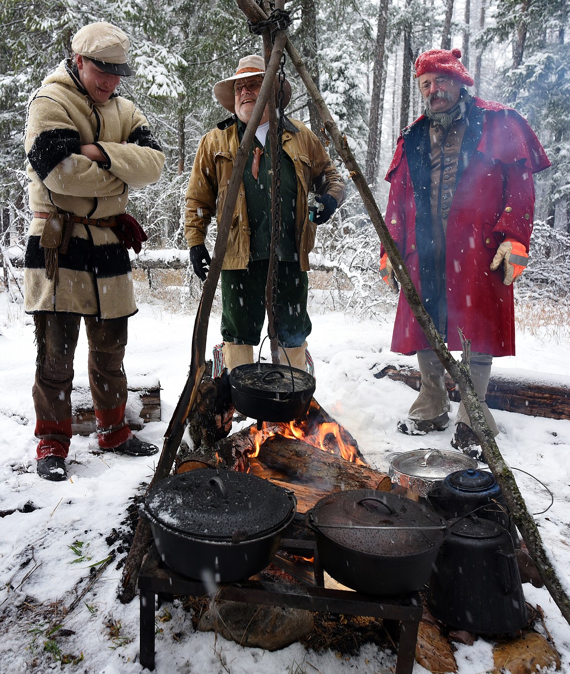 Flathead Muzzleloaders Association members Sean McQueen, Jon Erdman and Steve Radosovich trade stories around the campfire at the a gathering of the group near Columbia Falls Saturday. Dec. 4. (Jeremy Weber/Daily Inter Lake)