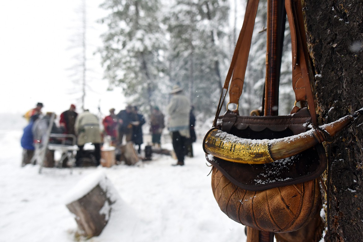 A powder horn and bag sit draped atop a rifle as the members of the Flathead Muzzleloaders Association gather around the campfire for lunch near Columbia Falls Saturday, Dec. 4. (Jeremy Weber/Daily Inter Lake)