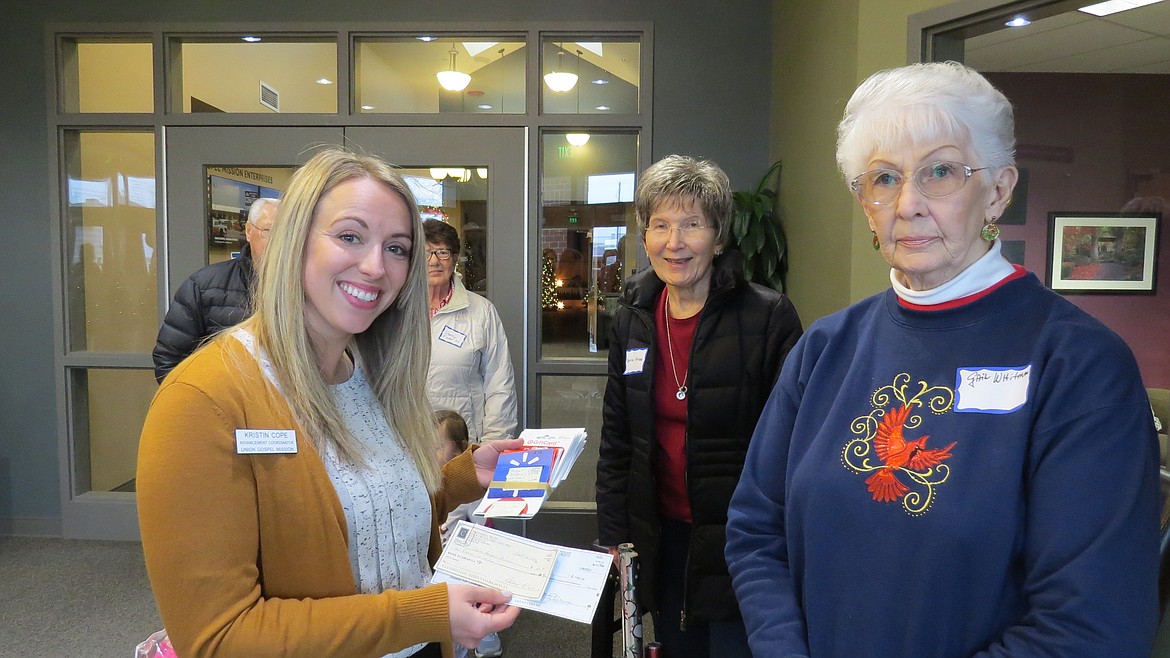 The Early Ford V-8 Club of America dropped off five bins full of love, toys, scarves and food to the Union Gospel Mission. Gail Whitman was the organizing force but additionally, the generosity of the club members was amazing. From left: Kristin Cope of UGM with Gail Whitman of the Ford Club, giving $1,700 in gift cards.