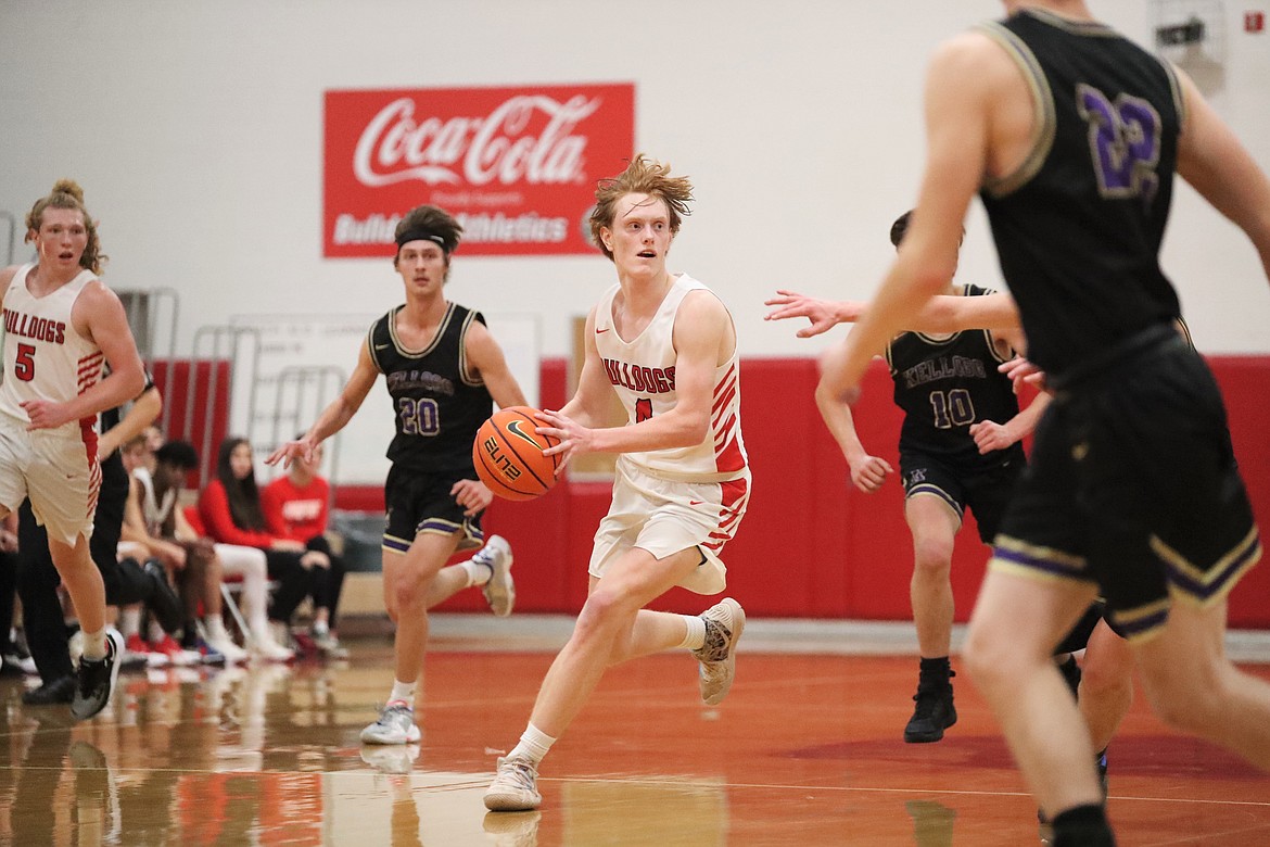 Rusty Lee brings the ball up the court and looks to make a pass Thursday.