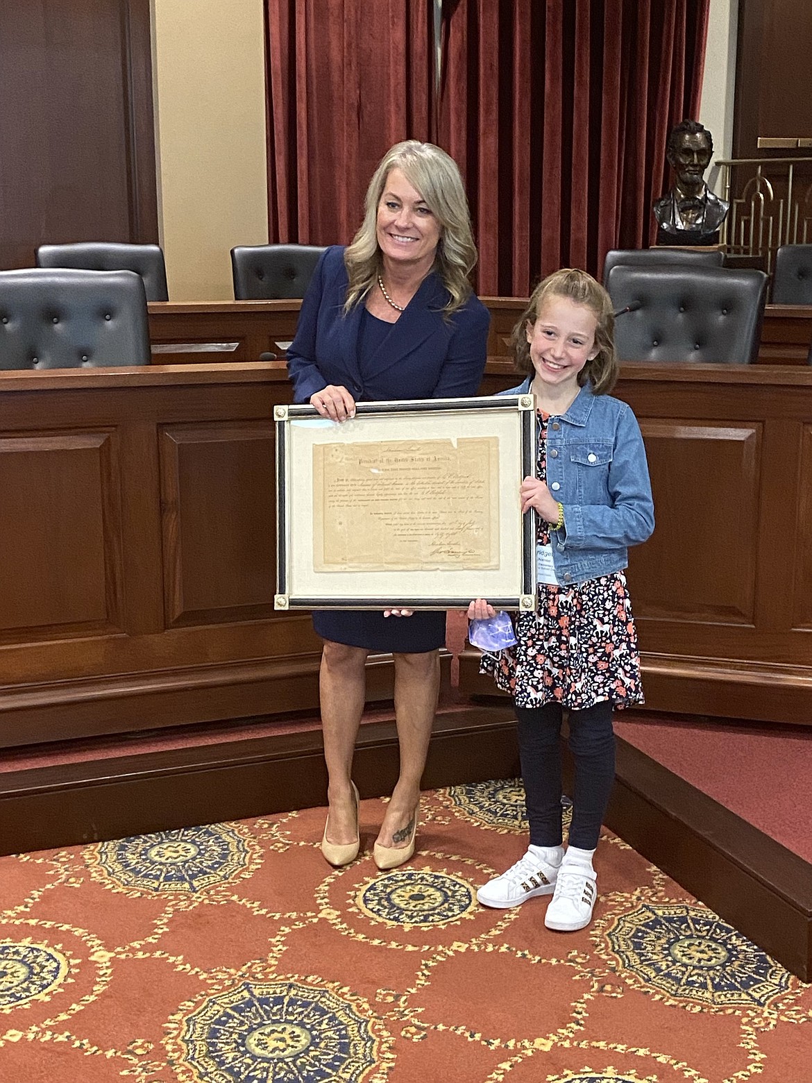 In her role on the state student advisory council for Idaho Superintendent of Public Instruction Sherri Ybarra, 9-year-old Bridget McNamee meets quarterly with the superintendent and other students in the council  in Boise. In this photo Ybarra and Bridget are holding the document signed by late President Abraham Lincoln creating Idaho Territory. Courtesy photo