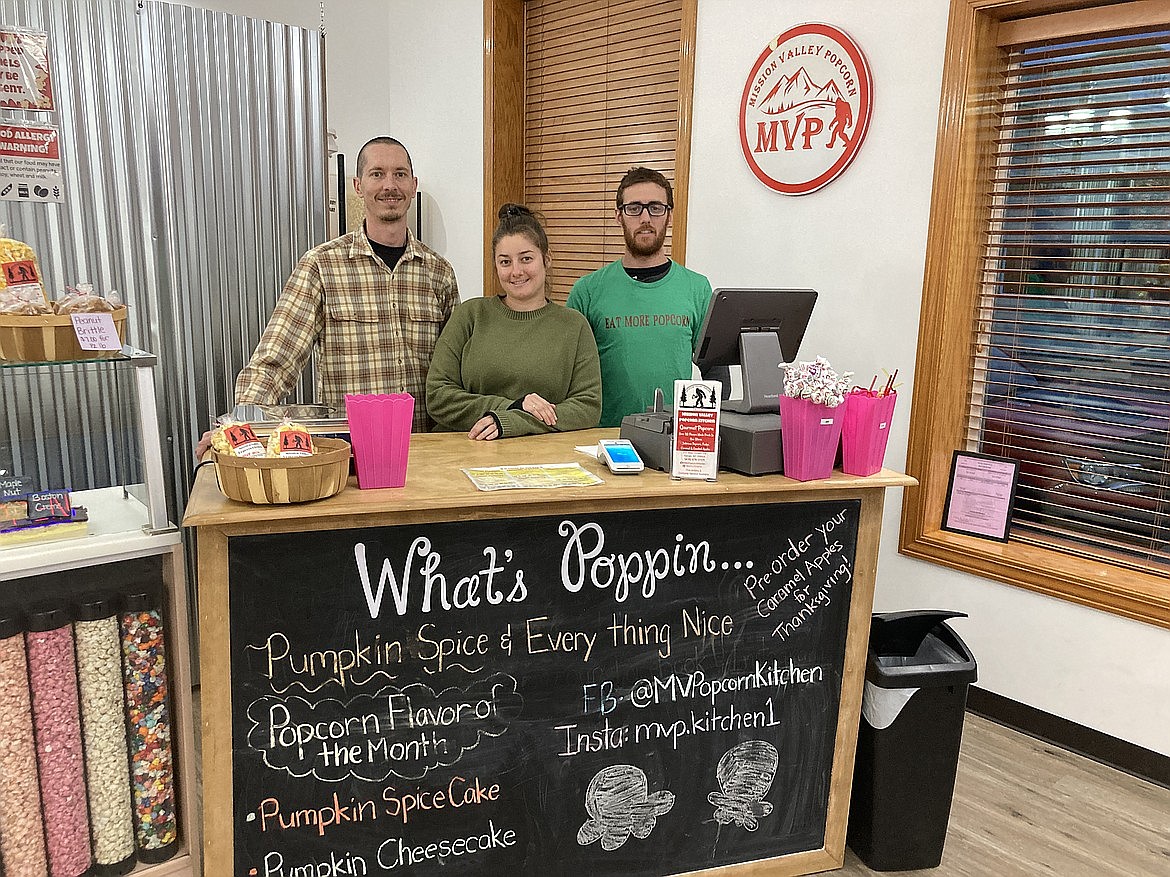 Meghan Gilligan, husband Dustin Thomas, left, and brother Shawn Gilligan offer up "anything your heart desires" for popcorn, fudge and candied apple treats and gifts at Mission Valley Popcorn Kitchen in Ronan. (Carolyn Hidy/Lake County Leader)