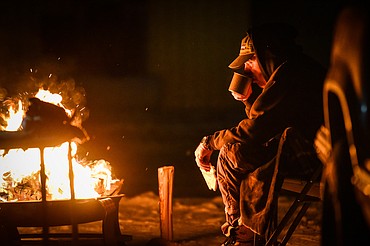 Tom Murphy sips a cup of coffee by the fire during When the Night Comes, a fundraiser held by the nonprofit Sparrow's Nest of Northwest Montana which benefits homeless high school students in the Flathead Valley on Friday, Dec. 10. Participants spent the night outdoors sleeping in cars and tents at the Flathead County Fairgrounds. Sparrow's Nest received over $42,000 in donations according to executive director Rachelle Morehead. (Casey Kreider/Daily Inter Lake)