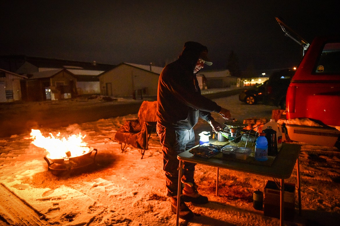 Tom Murphy sets up a propane burner to make coffee during When the Night Comes, a fundraiser held by the nonprofit Sparrow's Nest of Northwest Montana which benefits homeless high school students in the Flathead Valley on Friday, Dec. 10. Participants spent the night outdoors sleeping in cars and tents at the Flathead County Fairgrounds. Sparrow's Nest received over $42,000 in donations according to executive director Rachelle Morehead. (Casey Kreider/Daily Inter Lake)