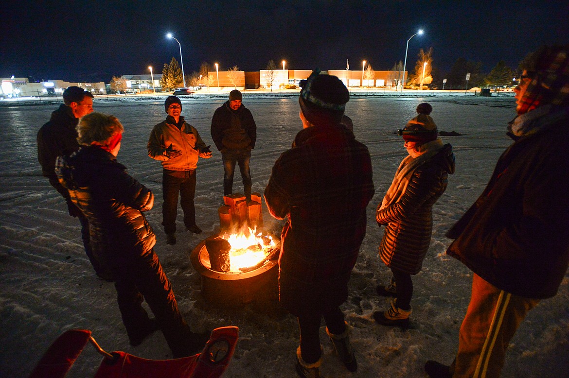 Participants gather around a fire to chat during When the Night Comes, a fundraiser held by the nonprofit Sparrow's Nest of Northwest Montana which benefits homeless high school students in the Flathead Valley on Friday, Dec. 10. Participants spent the night outdoors sleeping in cars and tents at the Flathead County Fairgrounds. Sparrow's Nest received over $42,000 in donations according to executive director Rachelle Morehead. (Casey Kreider/Daily Inter Lake)