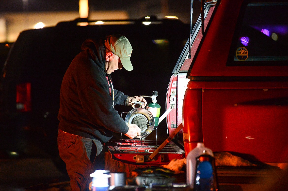 Tom Murphy works on a propane burner that wouldn't ignite during When the Night Comes, a fundraiser held by the nonprofit Sparrow's Nest of Northwest Montana which benefits homeless high school students in the Flathead Valley on Friday, Dec. 10. Participants spent the night outdoors sleeping in cars and tents at the Flathead County Fairgrounds. Sparrow's Nest received over $42,000 in donations according to executive director Rachelle Morehead. (Casey Kreider/Daily Inter Lake)