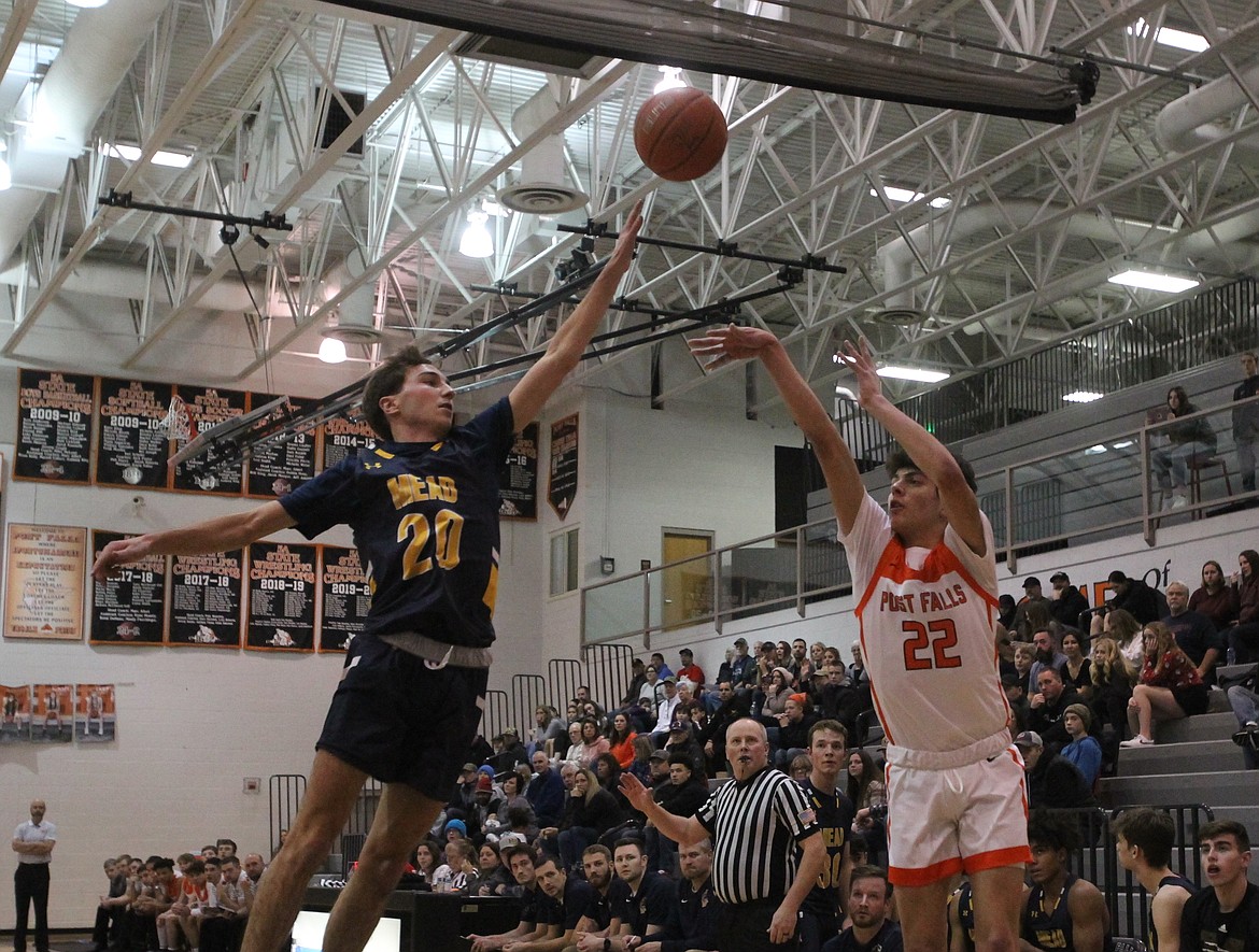 MARK NELKE/Press
Tyras Blake (22) of Post Falls launches a 3-pointer over the defense of Mead's Brycen Gardner on Saturday night at The Arena.