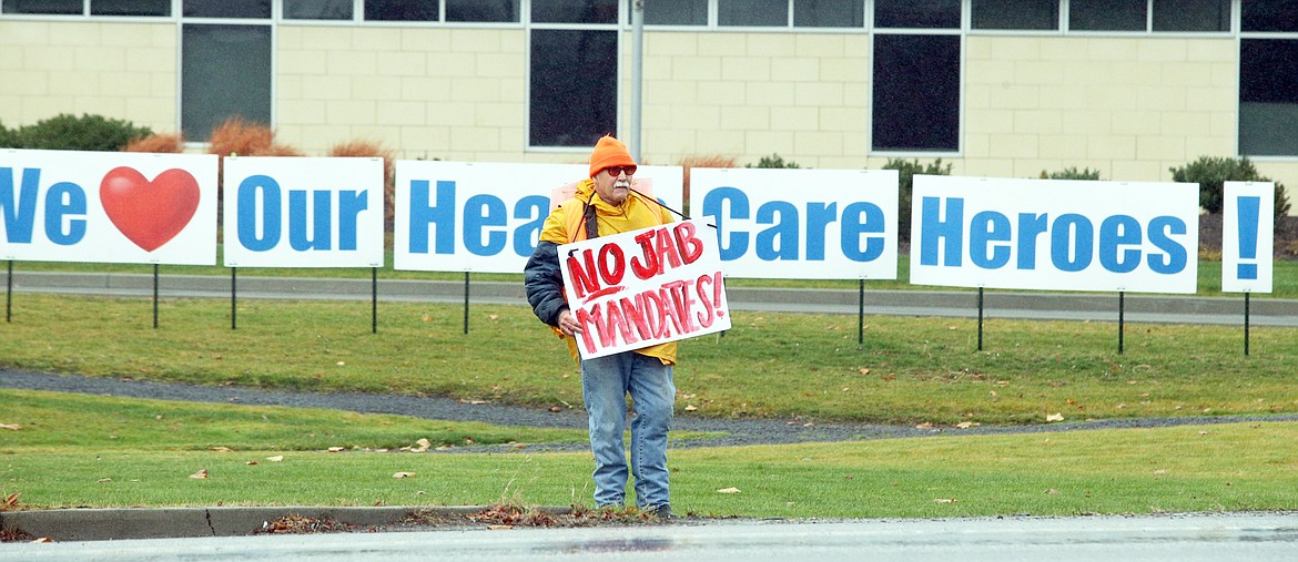 One man holds a sign outside Kootenai Health on Saturday.