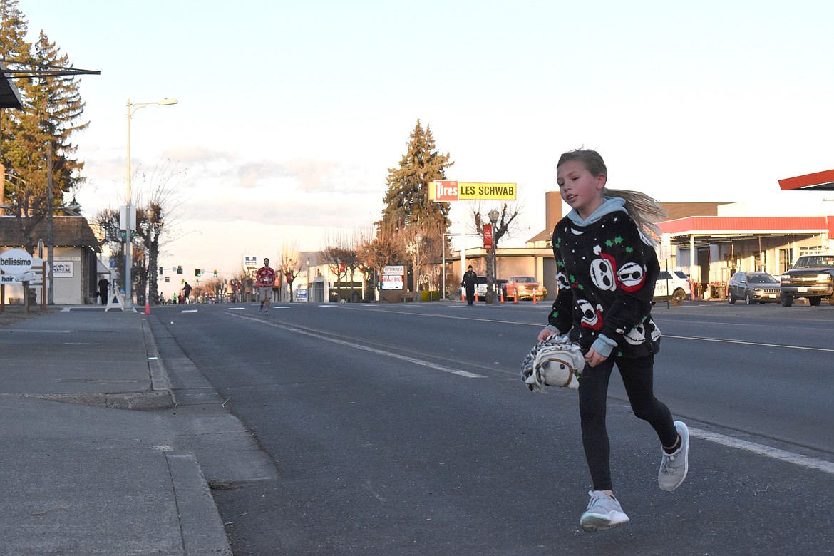 Nine-year-old Harlyn Magana was the very first racer to cross the finish line of the Jingle Bell Fun Run in Ephrata on Saturday. She ran the 1-mile course.