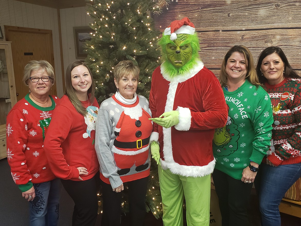 Volunteer of the Year Anton Kaufer dressed as the Grinch, with Evergreen Chamber staff.