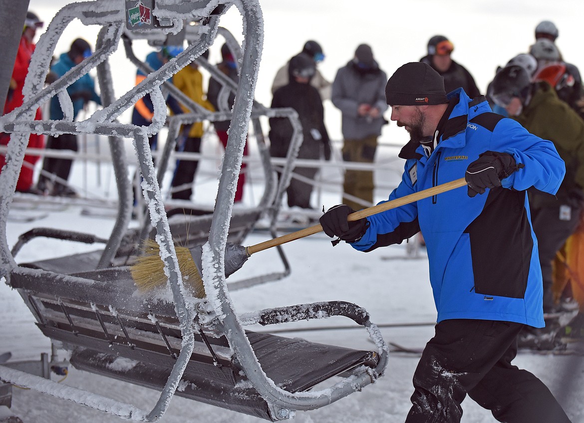 A WMR employee prepares the Chair 1 lift during Whitefish Mountain Resort's opening day of the 2021-22 season Thursday, Dec. 9. (Whitney England/Whitefish Pilot)