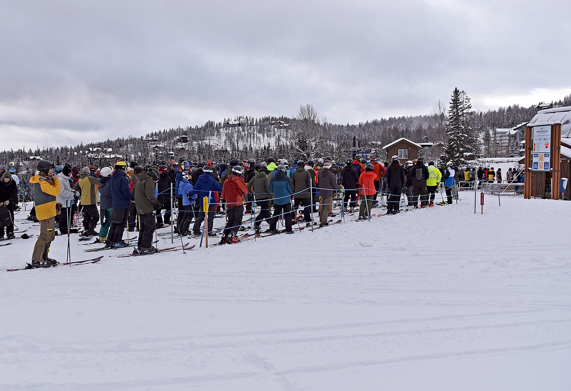 Skiers and snowboarders line up at Chair 1 for Whitefish Mountain Resort's opening day of the 2021-22 season Thursday, Dec. 9. (Whitney England/Whitefish Pilot)