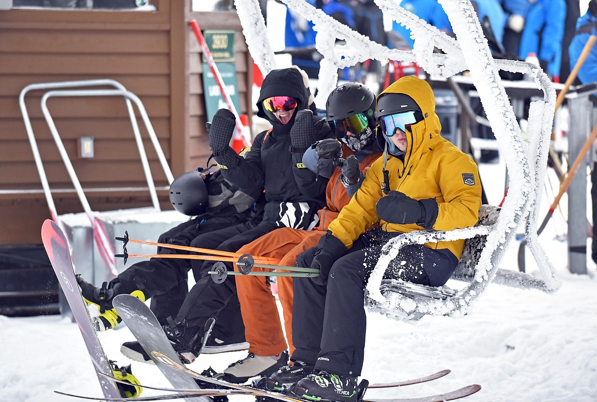 Columbia Falls High School students Anthony Tatum, Lane Anello, Keyaunn Wood and Payton Douglas catch the first chair at Whitefish Mountain Resort's opening day of the 2021-22 season Thursday, Dec. 9. (Whitney England/Whitefish Pilot)