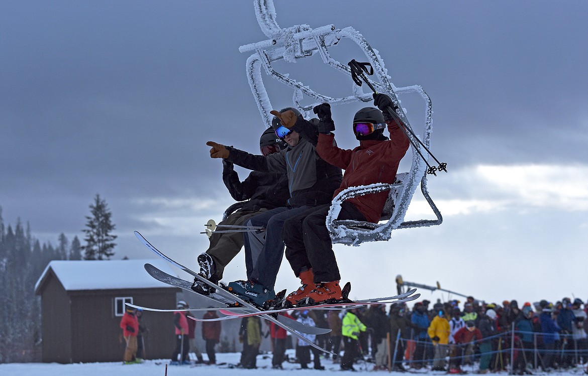 A group of skiers and snowboarders on their way up Chair 1 at Whitefish Mountain Resort's opening day of the 2021-22 season Thursday, Dec. 9. (Whitney England/Whitefish Pilot)