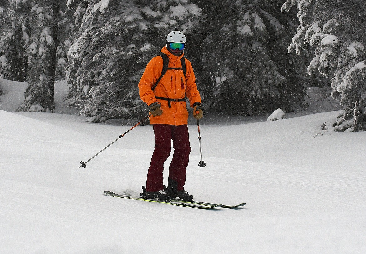 A skier is treated to a bit of fresh snow falling during Whitefish Mountain Resort's opening day of the 2021-22 season Thursday, Dec. 9. (Whitney England/Whitefish Pilot)