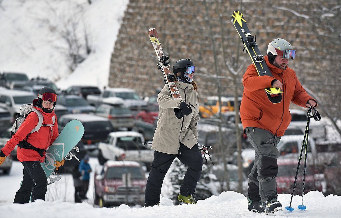 Eager skiers and snowboarders hike up from the Cedar Lot to catch Chair 1 for Whitefish Mountain Resort's opening day of the 2021-22 season Thursday, Dec. 9. (Whitney England/Whitefish Pilot)