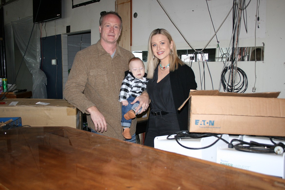 Owners Rob and Anna Van Diest, with son Rhett, stand behind the bar at the Broadway Bar & Grill.