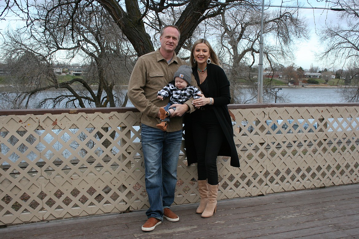 Broadway Bar & Grill owners Rob and Anna Van Diest, with son Rhett, stand on the restaurant deck.