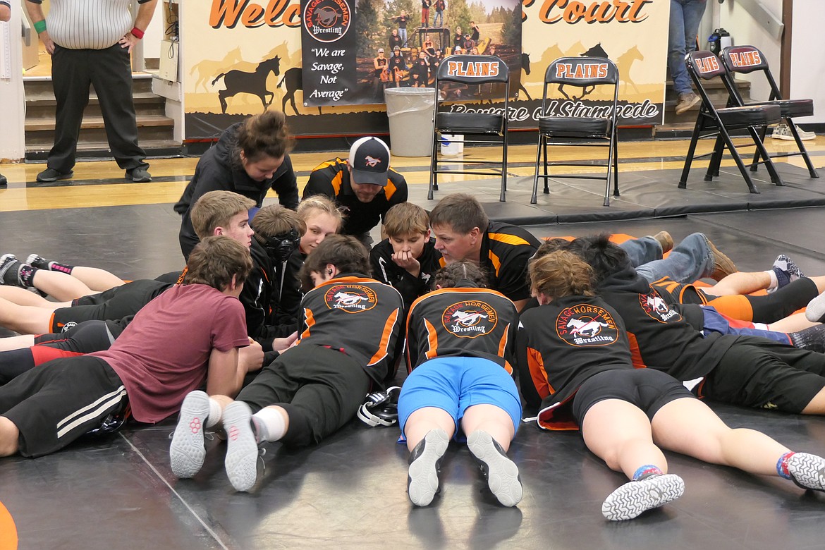 Plains wrestlers gather to listen to coach Shane Angle prior to the start of the Plains Quad meet Thursday in the Plains High Gym.  (Chuck Bandel/Valley Press)