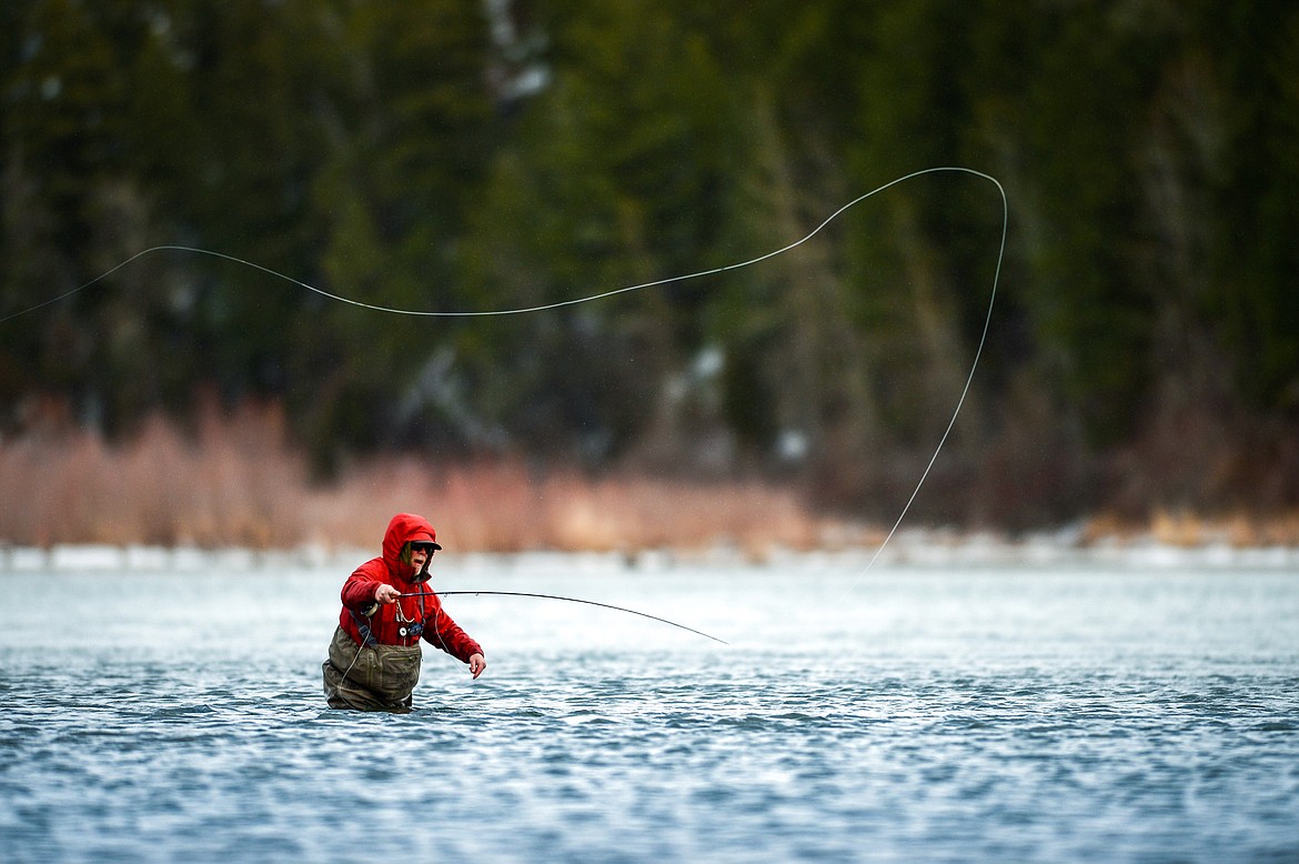 With temperatures hovering in the 30s, Dave Brown, who goes by the name "Bonefish Dave," casts into the Flathead River in search of cutthroat trout on Wednesday, Dec. 8. (Casey Kreider/Daily Inter Lake)